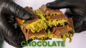 Blogs Close up of hands breaking open the viral Shake Shack Dubai Chocolate bar to reveal the thick, gooey green pistachio cream and crispy kunafa filling