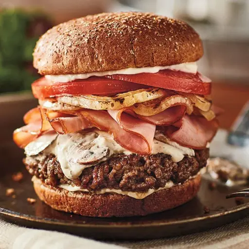 A juicy Shake Shack beef burger with cheese, lettuce, and tomato, displayed next to a detailed nutrition facts table showing calories, protein, and fat content.
