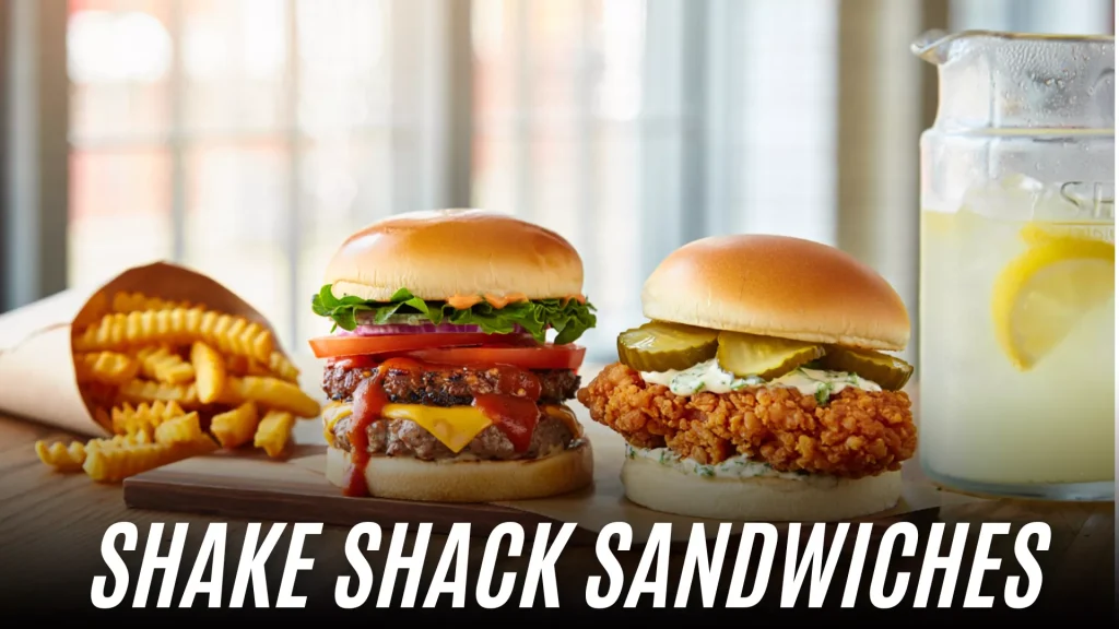Shake Shack chicken sandwich served with a burger, crinkle-cut fries, and lemonade on a wooden table