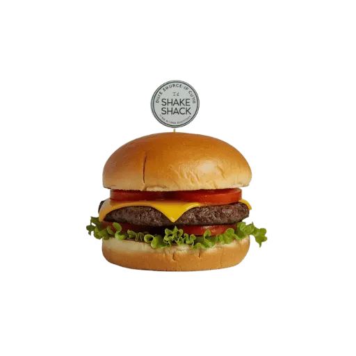 Shake Shack cheeseburger with signature metal token on top, beef patty, American cheese, lettuce, tomato, pickles - ShackBurger with iconic order token