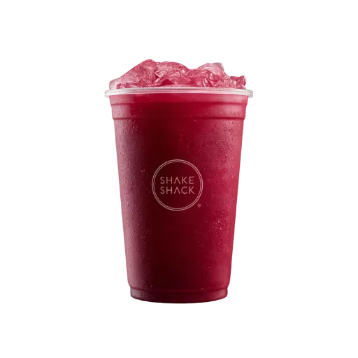 A refreshing Shake Shack deep-red berry lemonade served in a clear branded cup, topped with a large amount of crushed ice, showcasing a cold and fruity beverage texture.