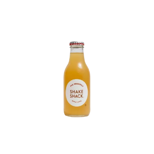 A glass bottle of Shake Shack branded apple juice, featuring a minimalist white circular logo and filled with clear, golden-colored natural fruit juice.