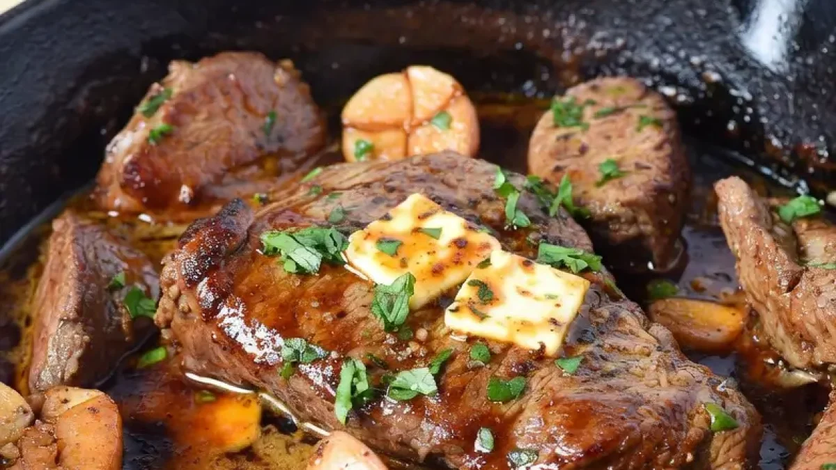 garlic butter basting in a hot cast iron skillet – juicy steak bites ready to serve